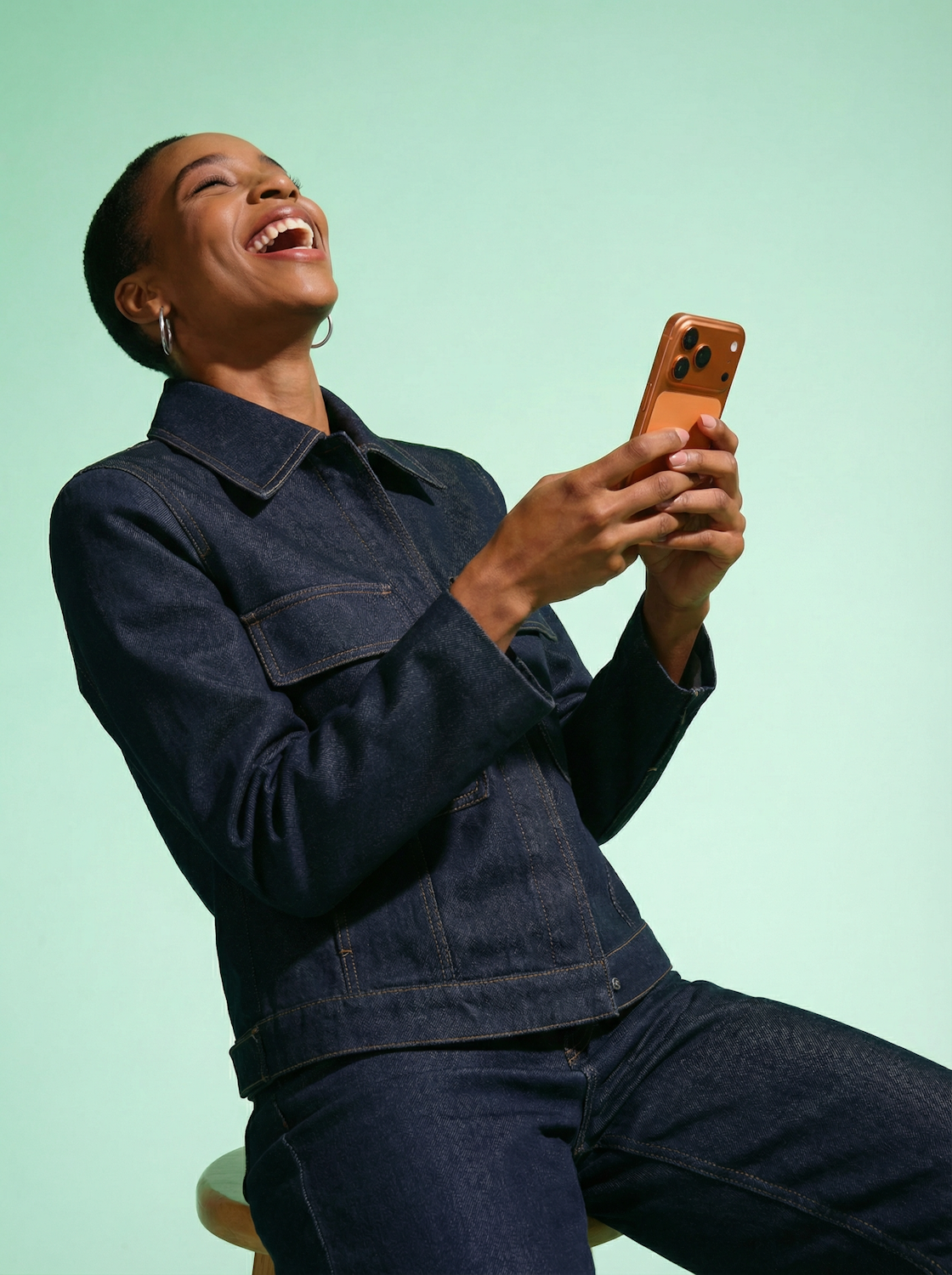 A person laughs genuinely while reading a digital book on a tablet, emphasizing the joy of finding truly funny content through careful selection.