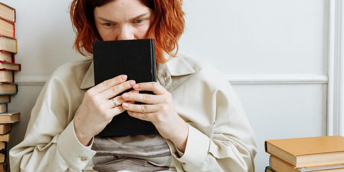 A person deeply engrossed in a book, reflecting the thoughtful engagement Miller's stories inspire.