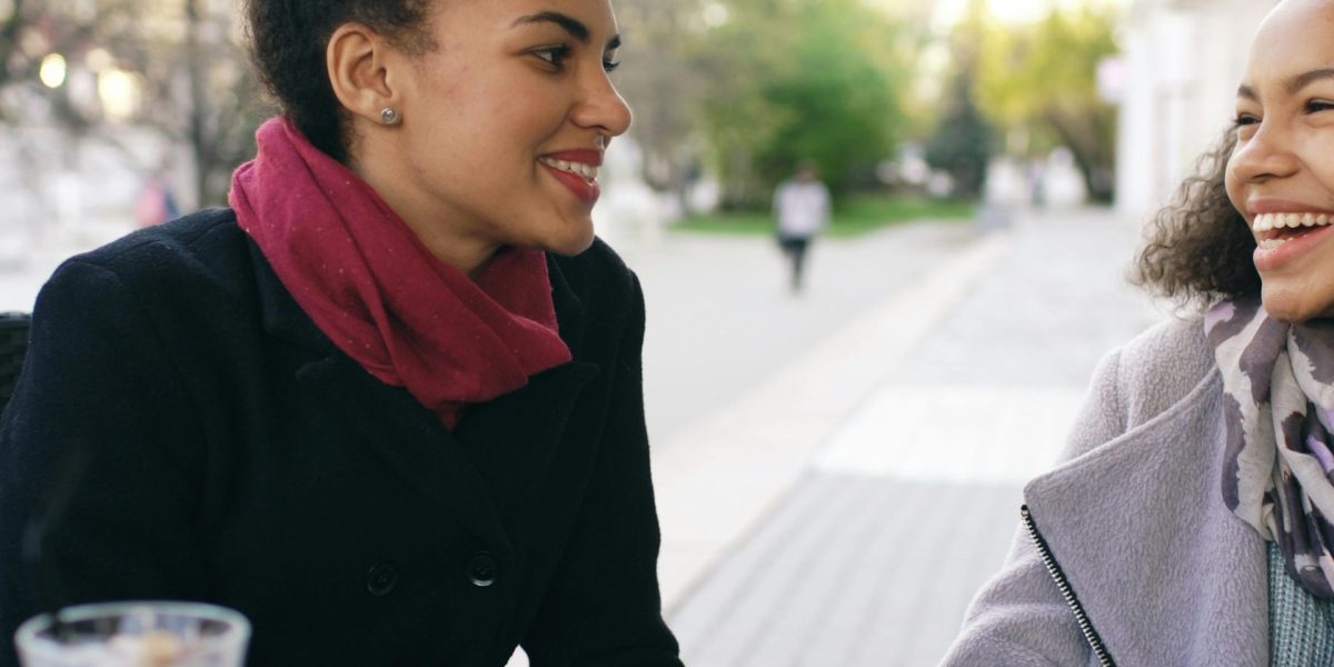 Two individuals engaged in a deep conversation or sharing a quiet, reflective moment, evoking companionship.