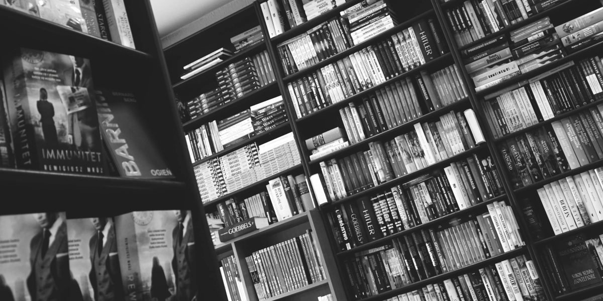 A person happily exploring books, ready to choose their next read.