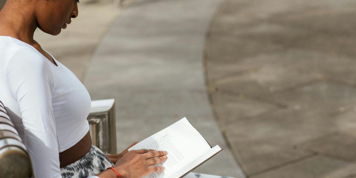 Stock-photo-style scene of a reader reflecting on complex characters and moral questions.