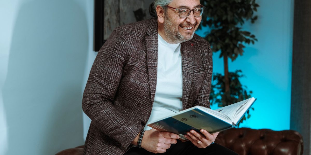 A person laughs genuinely while immersed in a captivating book, reflecting the joy of finding perfect humor.