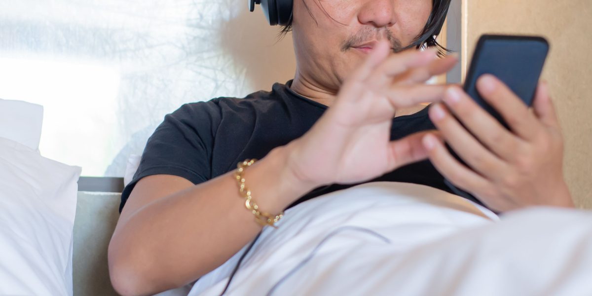 Enjoying the narrative of a story through the immersive experience of an audiobook.